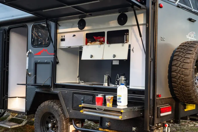 blue tongue camper xh16 hybrid caravan outdoor kitchen in use